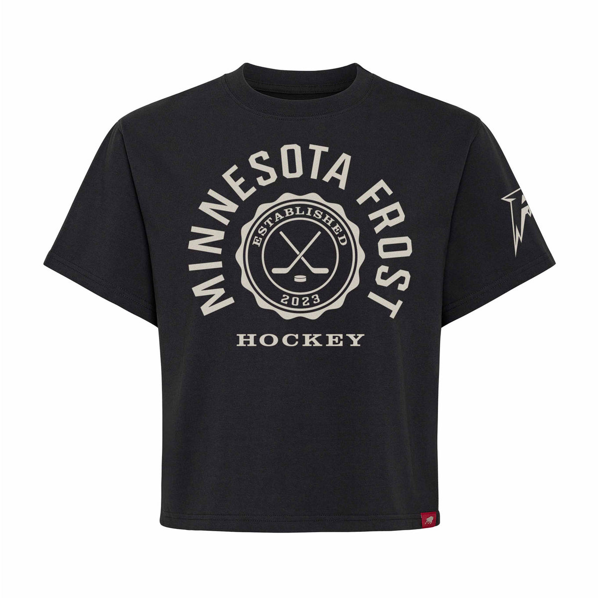 Front of a black short sleeve shirt. 'MINNESOTA FROST' is written in a white arch of text around a circular emblem with crossed hockey sticks and 'ESTABLISHED 2023' inside with 'HOCKEY' below it. A white Minnesota Frost logo is on the left sleeve.