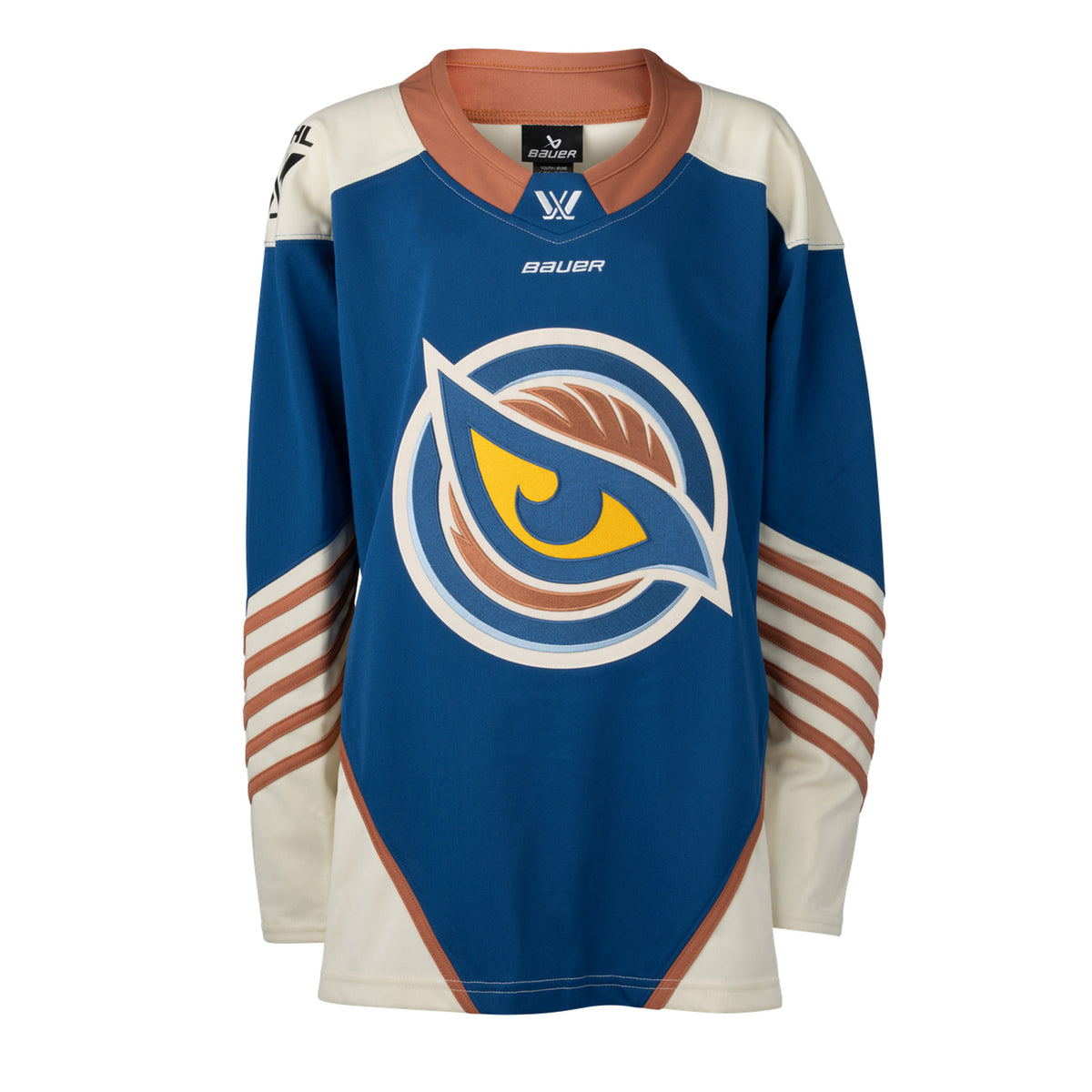 Front of a blue jersey with the Vancouver Goldeneyes logo in the center. The hips have cream color blocking with a tan line on top. The tan collar has a blue color block with the PWHL logo and the Bauer logo is beneath it. The cream shoulder caps have the PWHL logo on the left shoulder. From the elbow down is cream with small tan stripes.