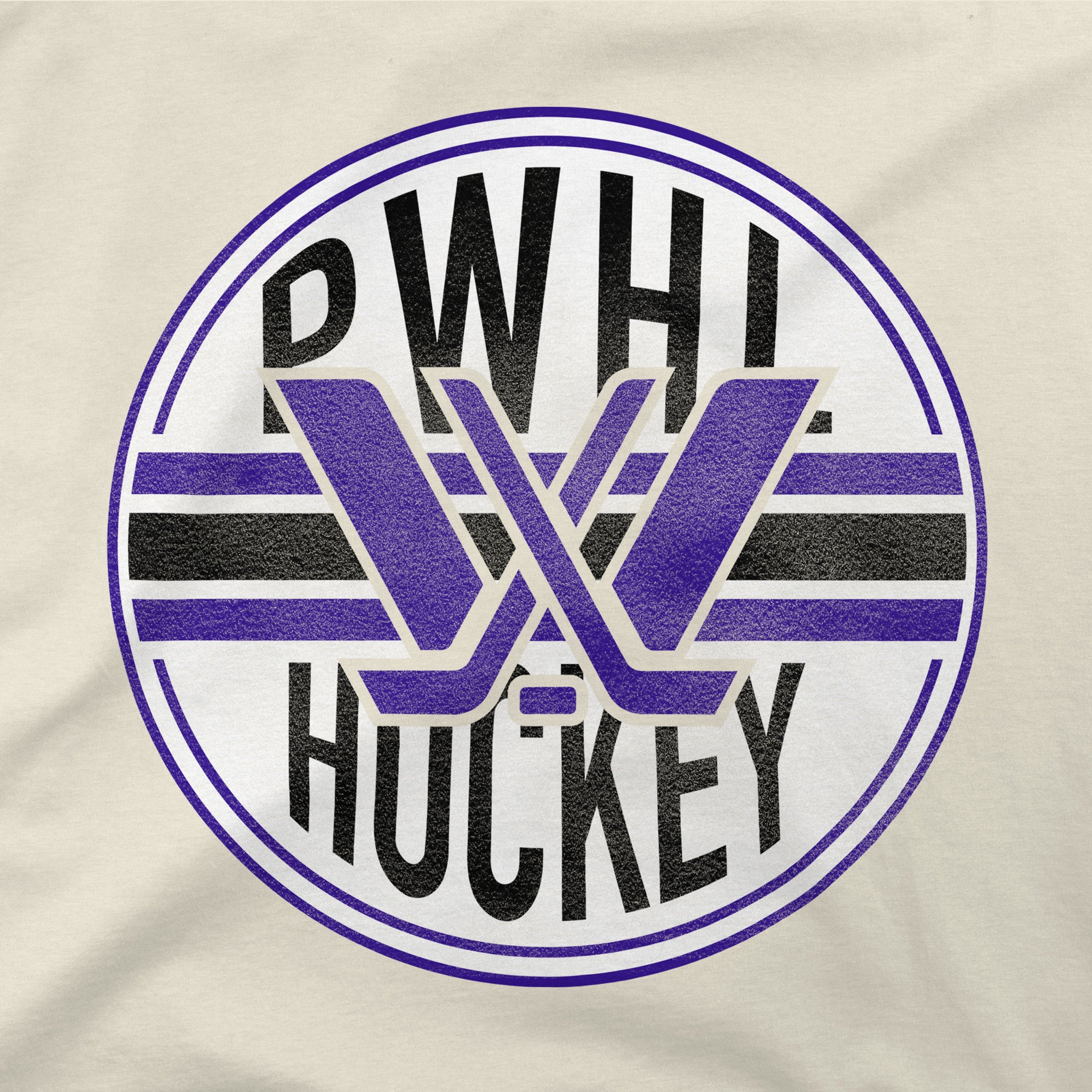 A close-up of a circular graphic printed on a light beige fabric, featuring the text 'PWHL HOCKEY' in black with purple and black hockey sticks forming a stylized 'W' in the center.