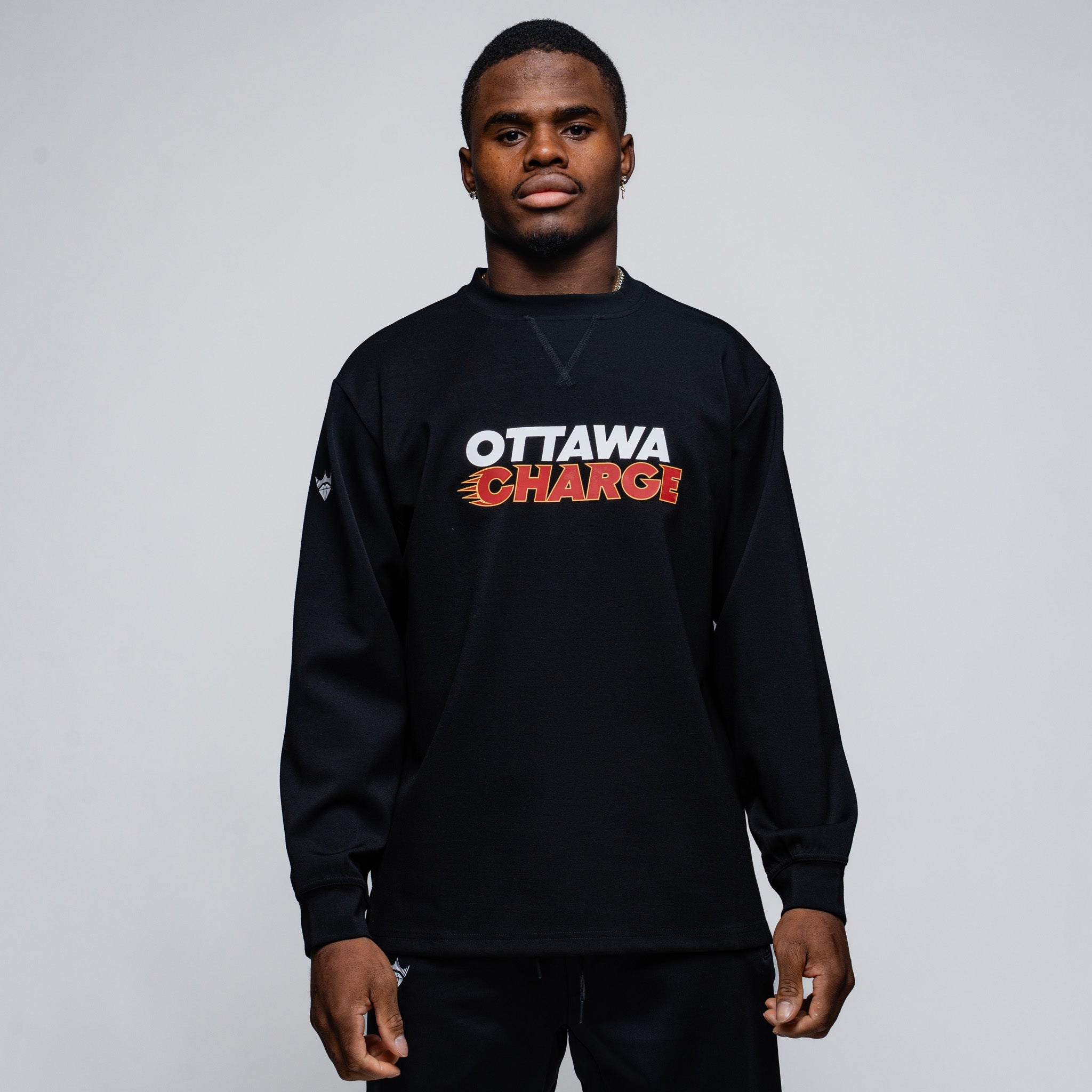 Person wearing a black sweatshirt with 'Ottawa Charge' text on a gray background