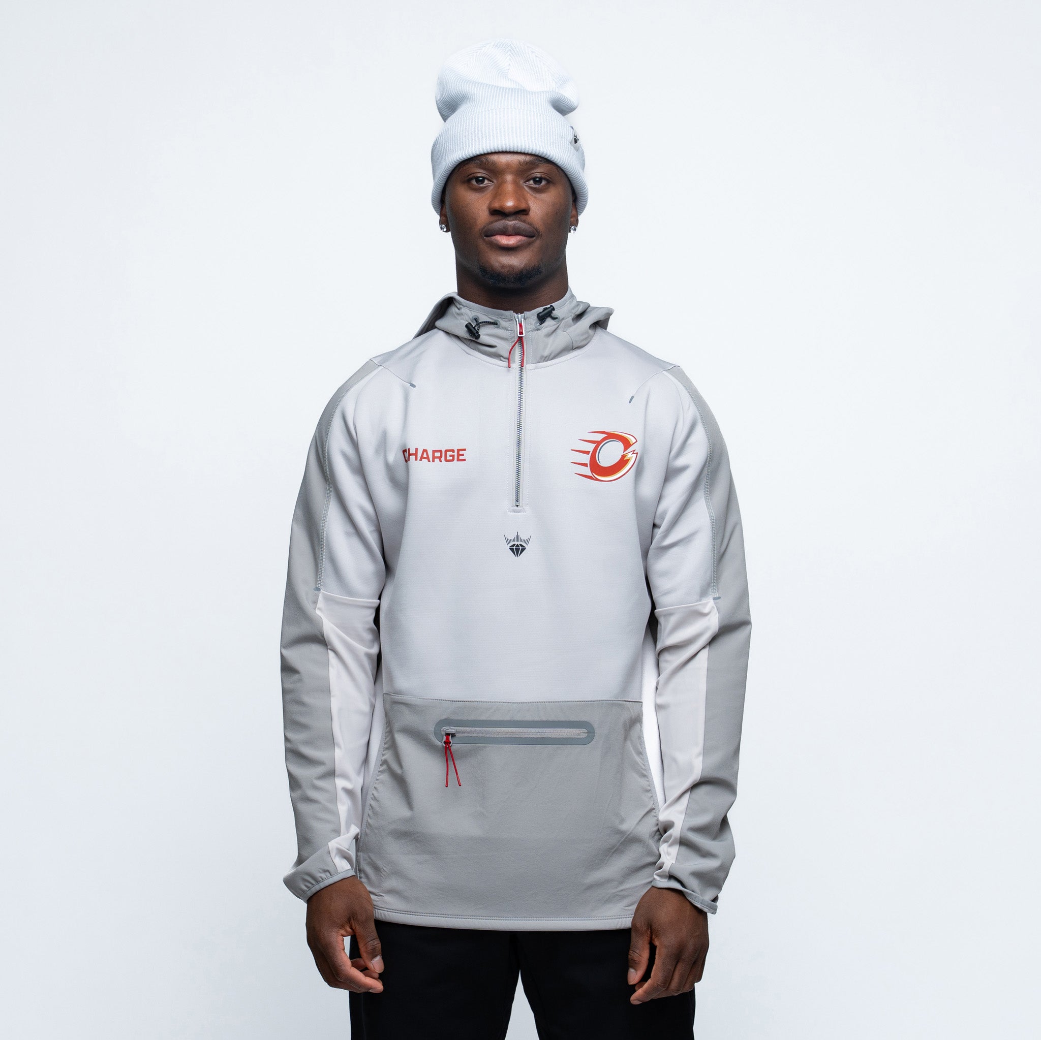 Person wearing a gray jacket with brand logos on a white background