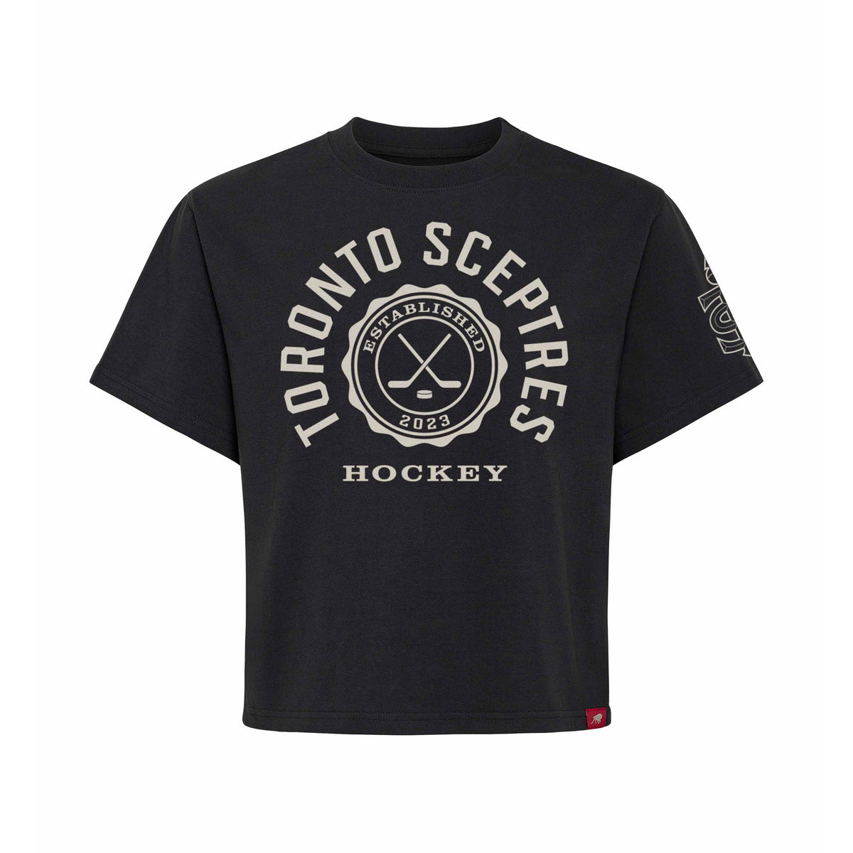 Front of a black short sleeve shirt. 'TORONTO SCEPTRES' is written in a white arch of text around a circular emblem with crossed hockey sticks and 'ESTABLISHED 2023' inside with 'HOCKEY' below it. A white mono-color Toronto Sceptres logo is on the left sleeve.