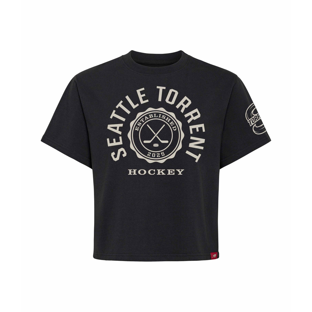 Front of a black short sleeve shirt. 'SEATTLE TORRENT' is written in a white arch of text around a circular emblem with crossed hockey sticks and 'ESTABLISHED 2025' inside with 'HOCKEY' below it. A white mono-color Seattle Torrent logo is on the left sleeve.