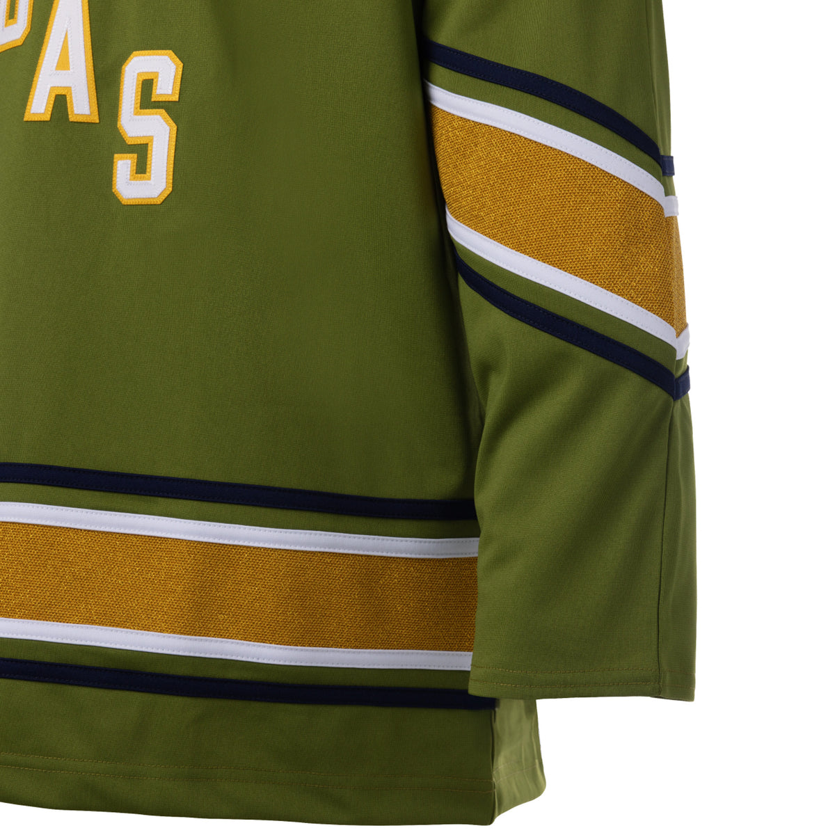 Front of a green jersey with sparkling gold stripes along the sleeves and bottom hem surrounded by white and black stripes. In white outlined in gold reads 'VEGAS' diagonally across the chest.
