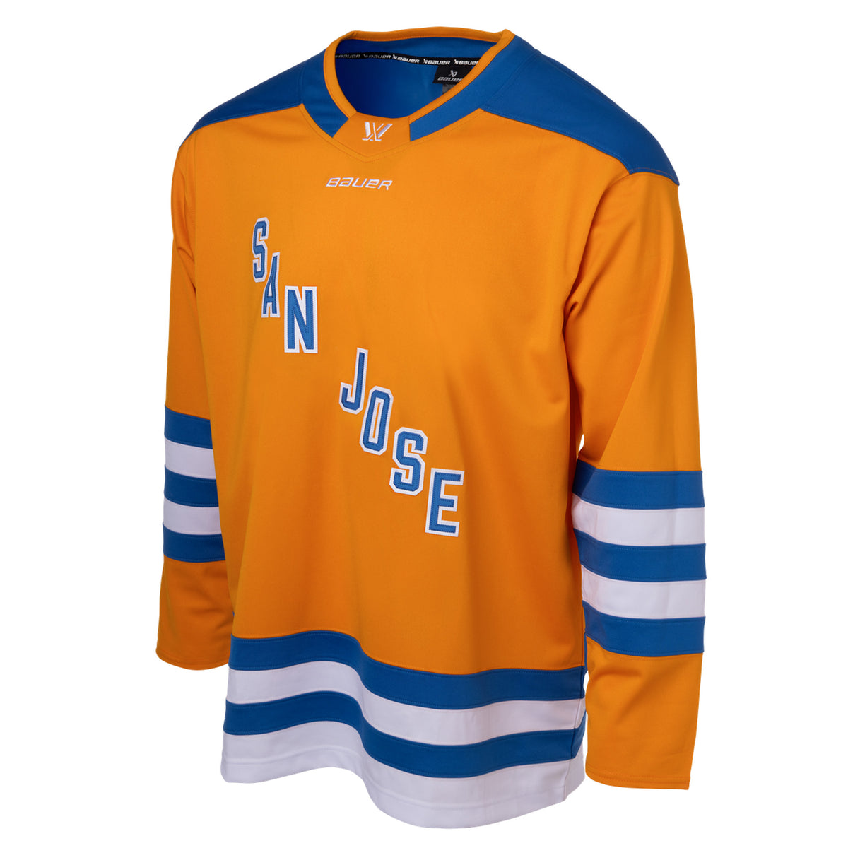 Front of an orange jersey with blue shoulder caps and blue and white stripes along the sleeves and bottom hem. In blue with white outlining is 'SAN JOSE' diagonally across the chest. The collar is blue with orange trim and color blocking on the front to showcase a white PWHL logo and a white Bauer logo below it. 