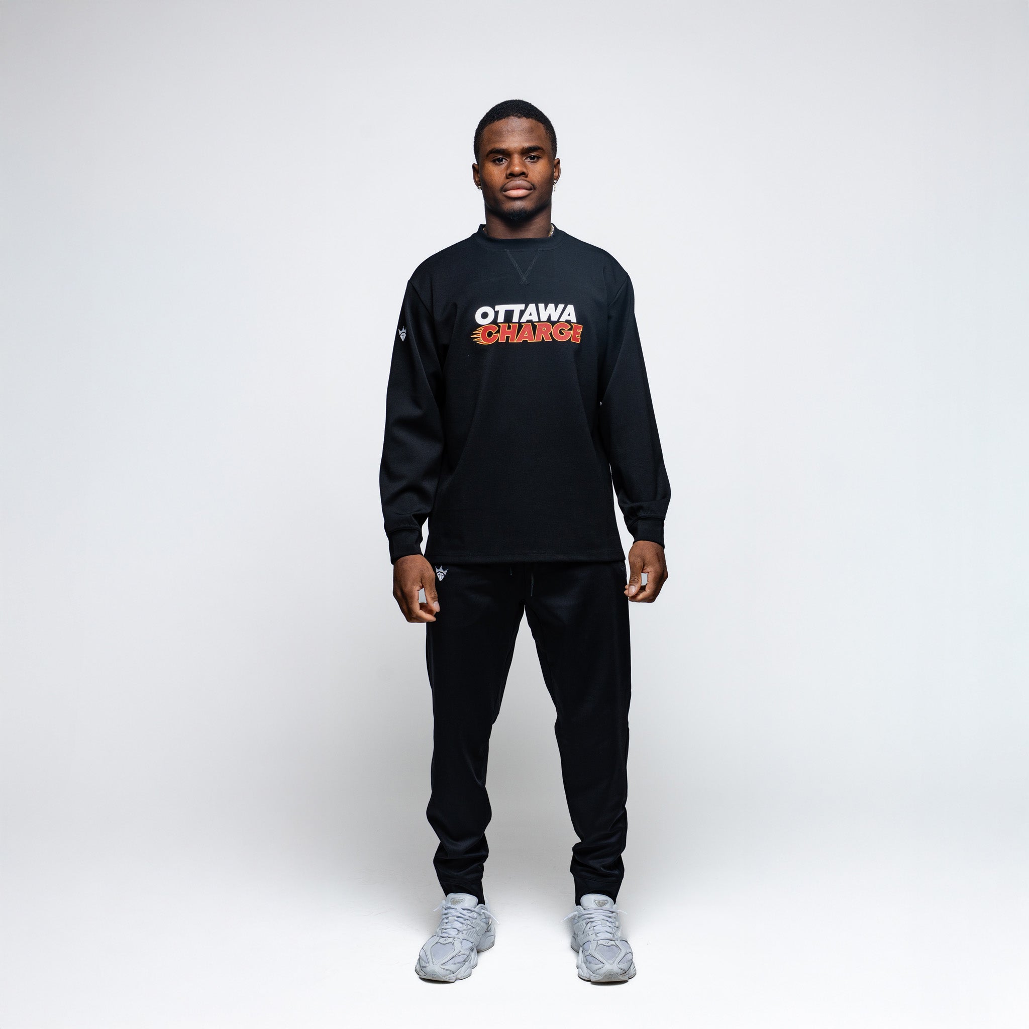 Person wearing a black sweatshirt with 'Ottawa Senators' text on a white background